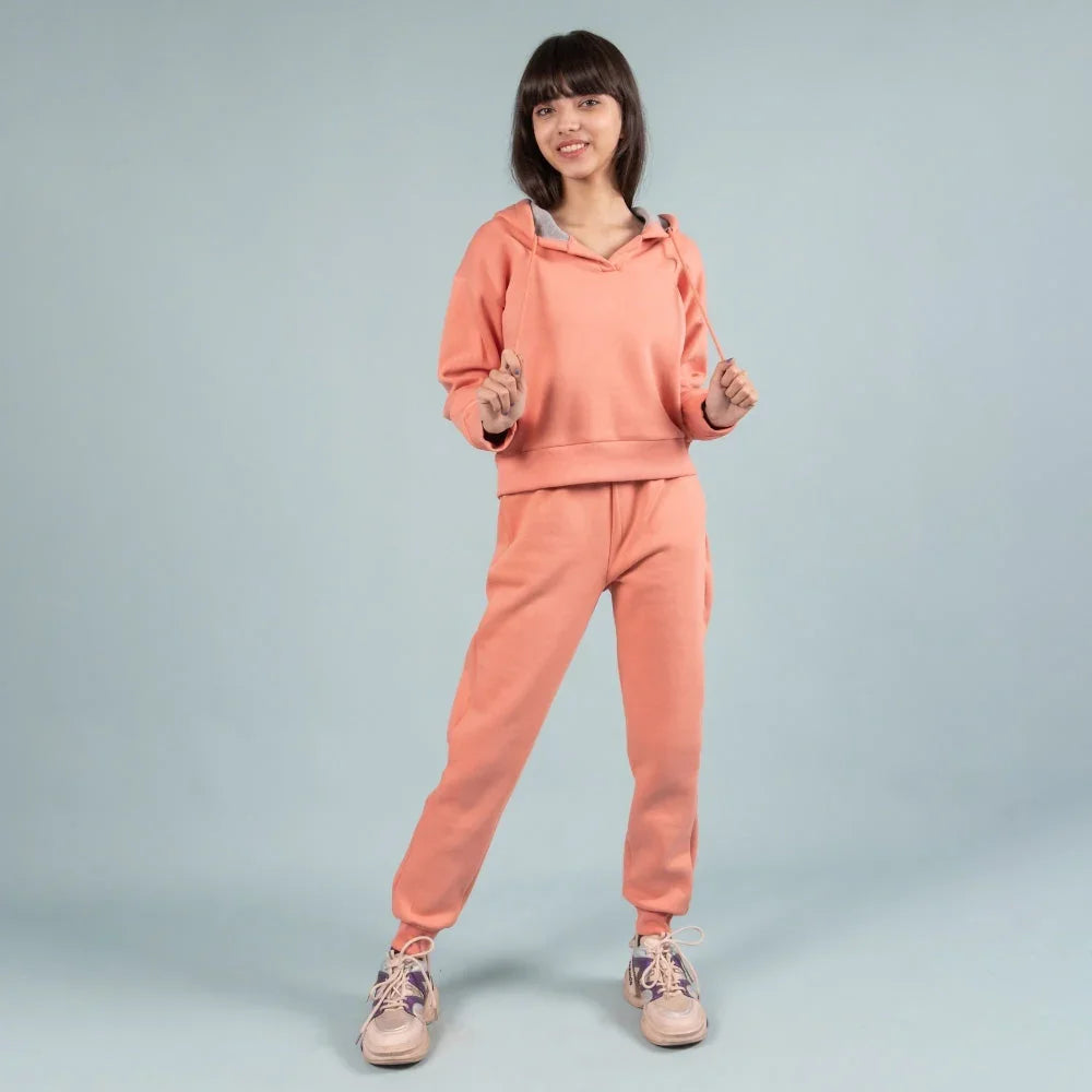 Girl wearing peach joggers set with hoodie, stylish kids loungewear for 10-year-old girls