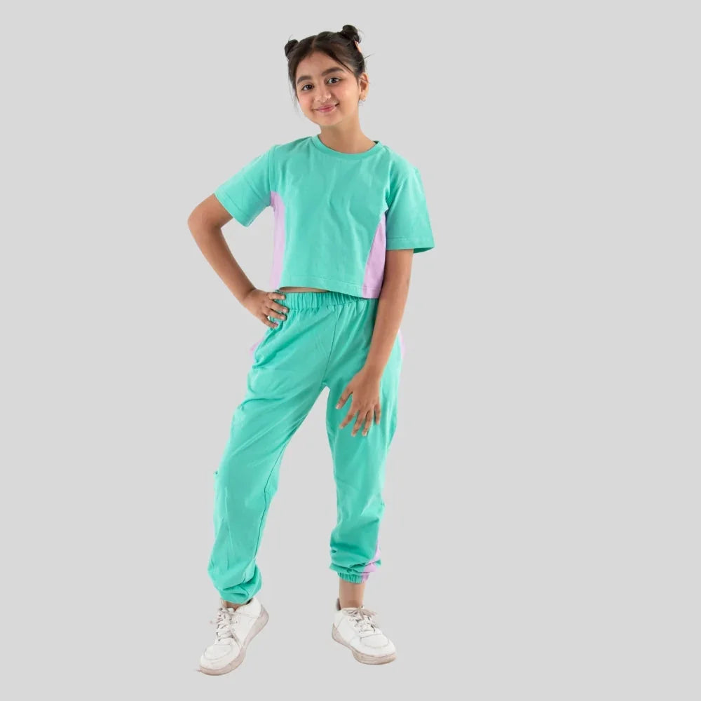 Girl wearing mint green jogger set with short sleeve top and matching jogger pants