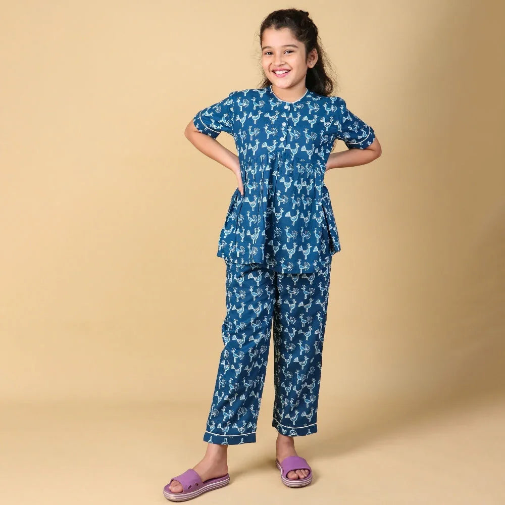 Girl wearing blue printed night suit set with short sleeves and matching pants