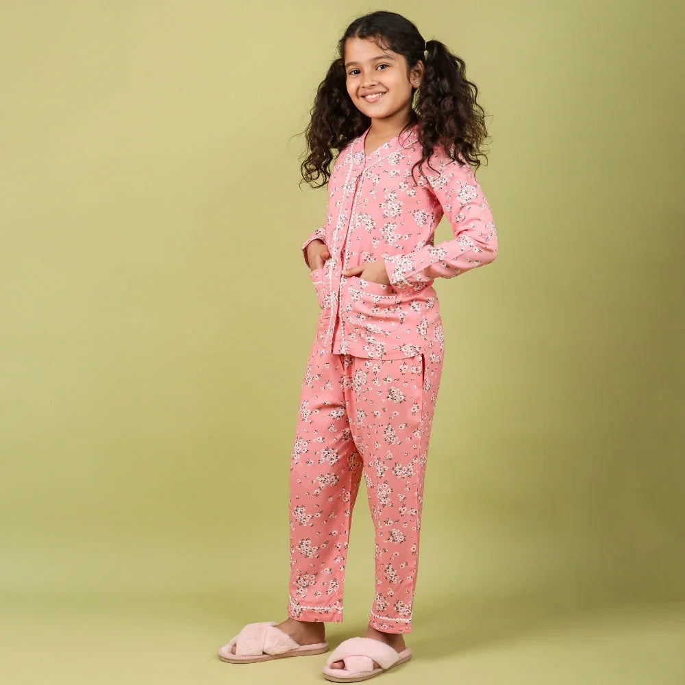 Young girl in pink floral nightdress set for girls, age 4 years, posing indoors