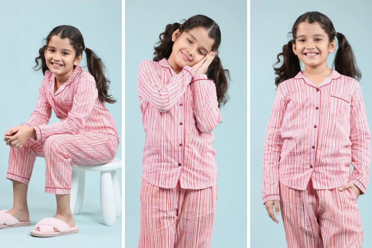 Smiling girl wearing pink striped night suit pajamas for kids, cozy and stylish sleepwear