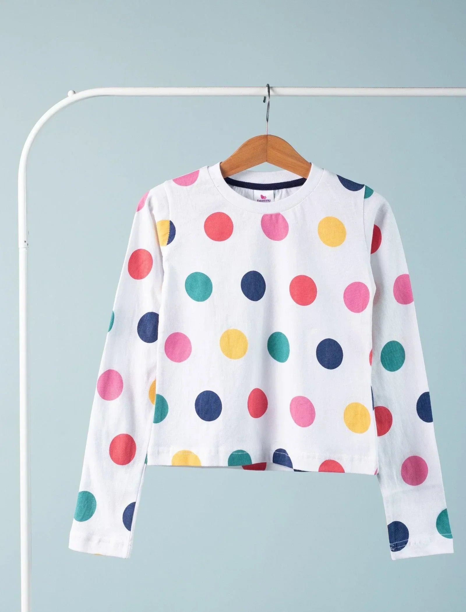 White long sleeve girls' top with colorful polka dots, hanging on wooden hanger