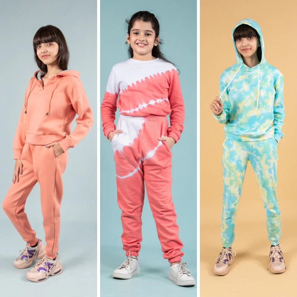 Girls modeling winter joggers sets in solid peach, pink tie-dye, and blue tie-dye styles