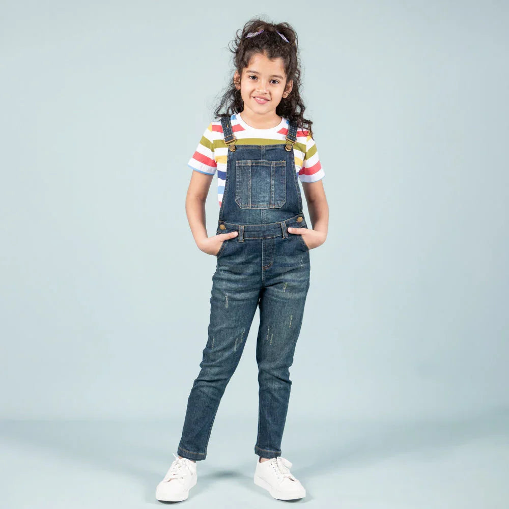Girl wearing blue denim dungaree and striped t-shirt, kids fashion for 12 year olds